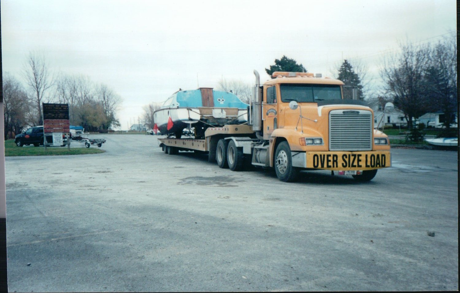 Freightliner hauling a boat, oversize load
